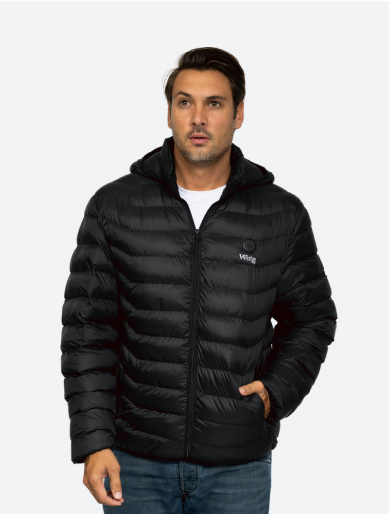 Man wearing a black puffer jacket with hood and hands in pockets, standing against a plain background.