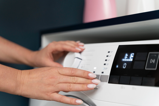 Woman choosing a program for the washing machine